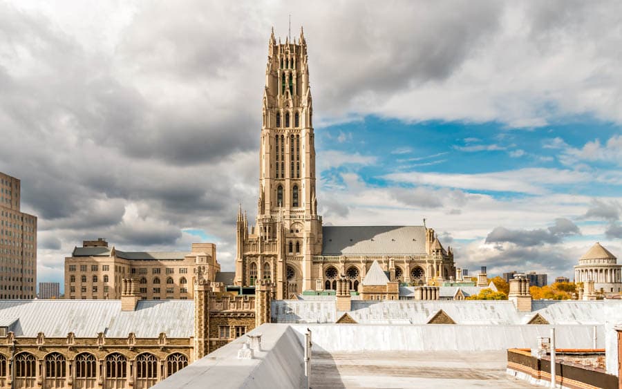 紐約市區中的河濱教堂（Riverside Church）高聳石塔，展現壯麗的哥德復興式風格，周邊環繞著現代與傳統並存的建築群。